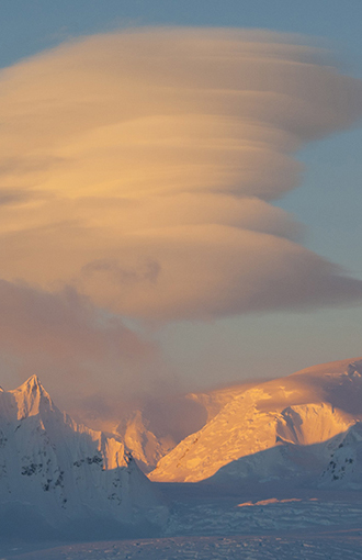 Lenticular clouds over the mountains of Antarctica.