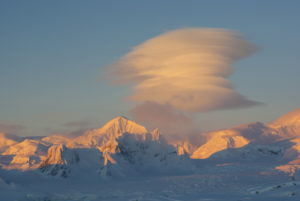 Lenticular clouds over the mountains of Antarctica.